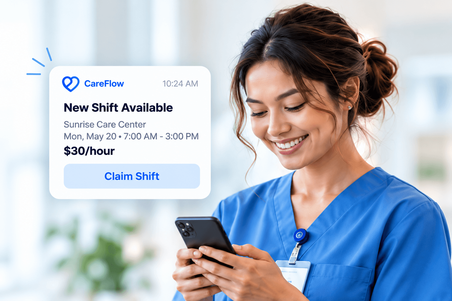 Caregiver in blue scrubs checking a phone with a CareFlow shift notification
